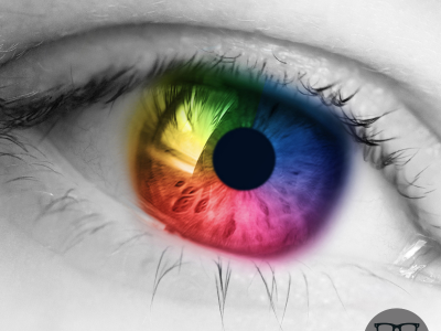 black and white image of an eye - with the iris artifically coloured to include the colours of the rainbow EYES on St Albans style